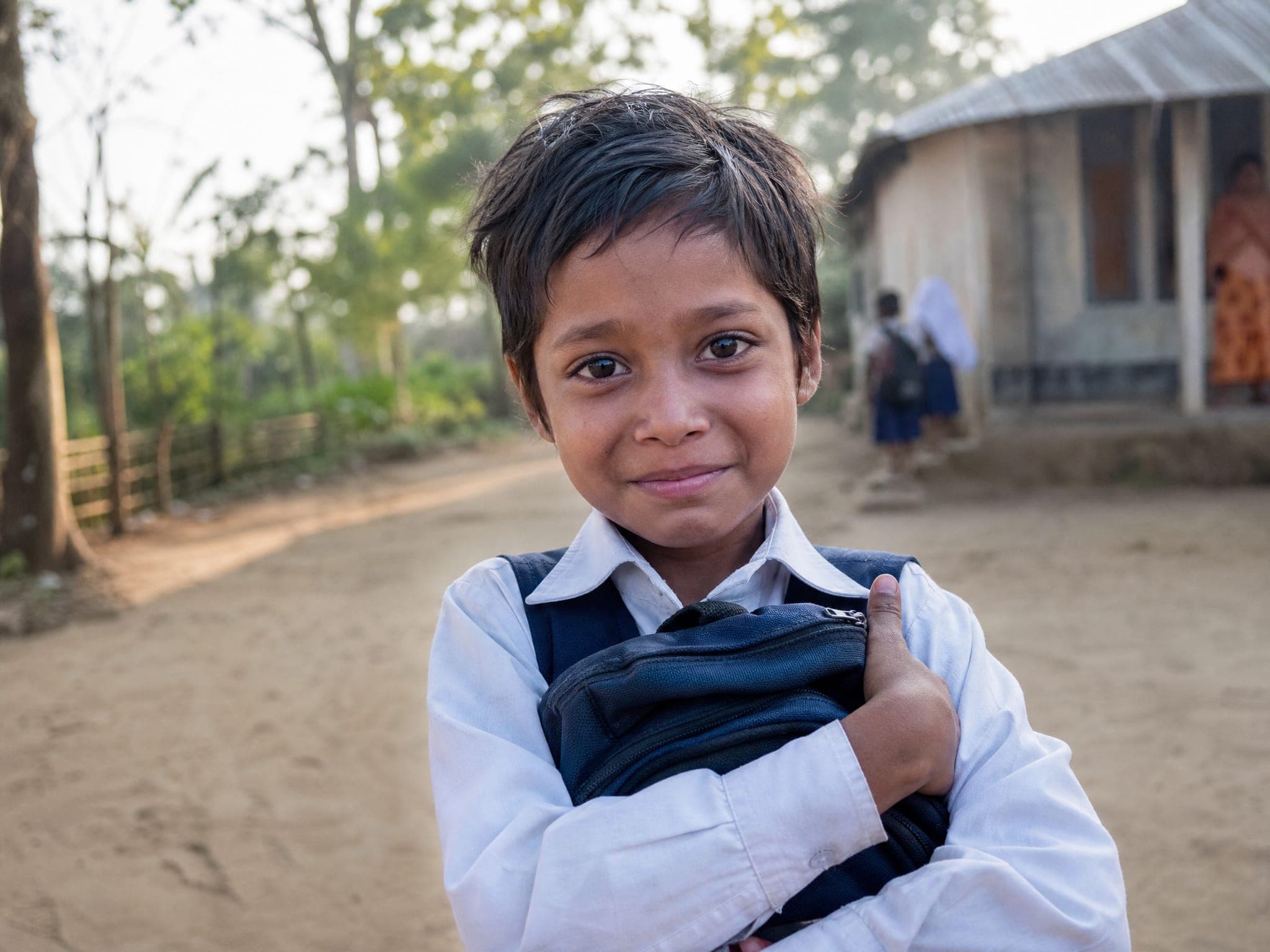 A child carrying a story still being written